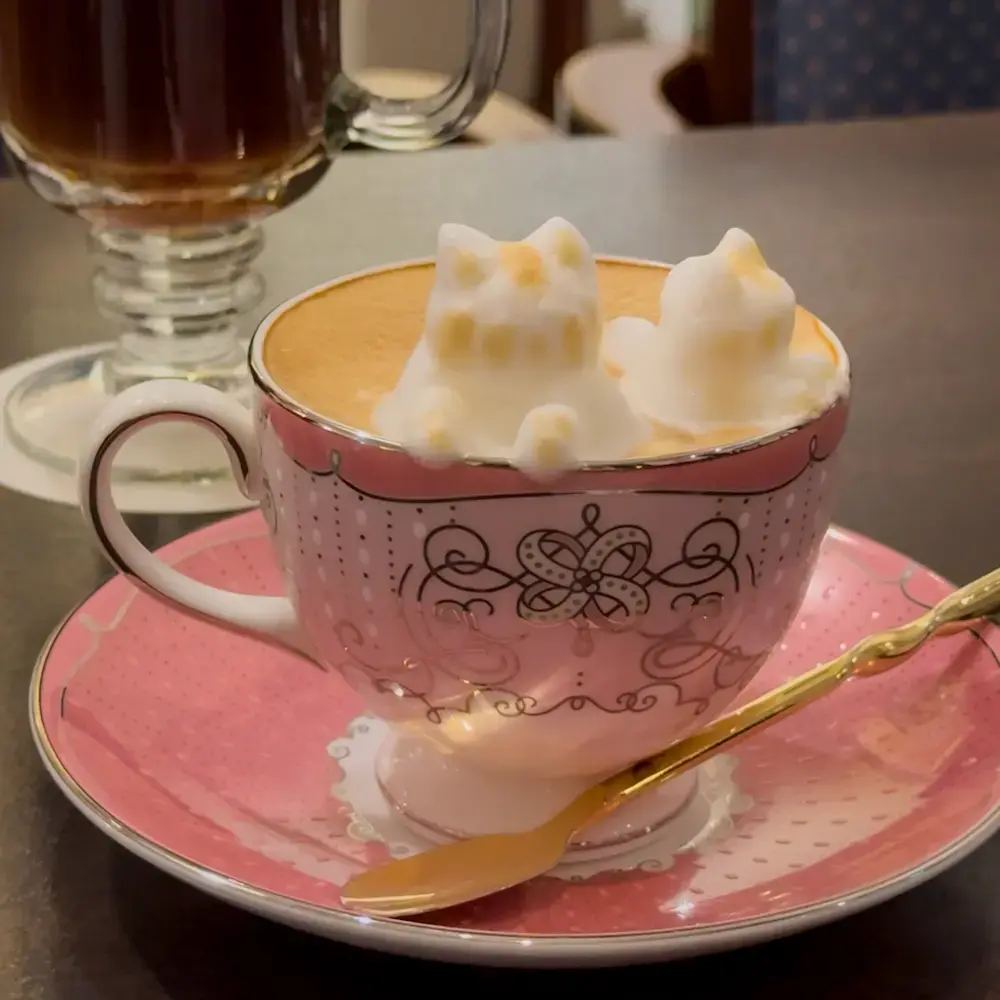 3D cat latte art in a pink teacup at a Tokyo café